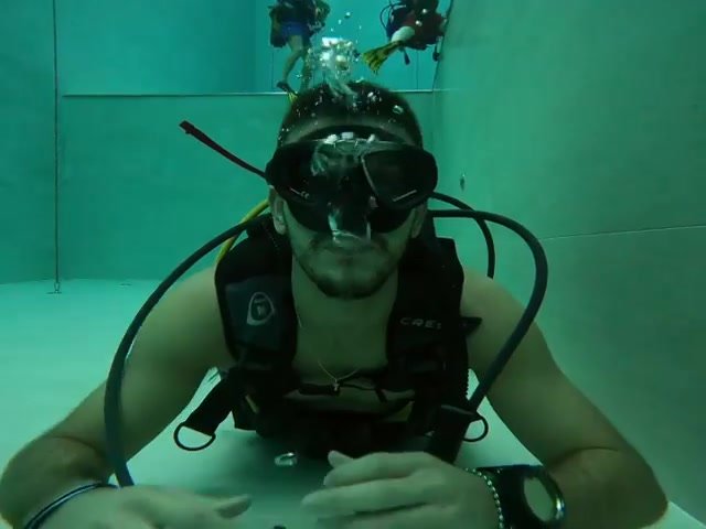 Scubadiver underwater with reg off