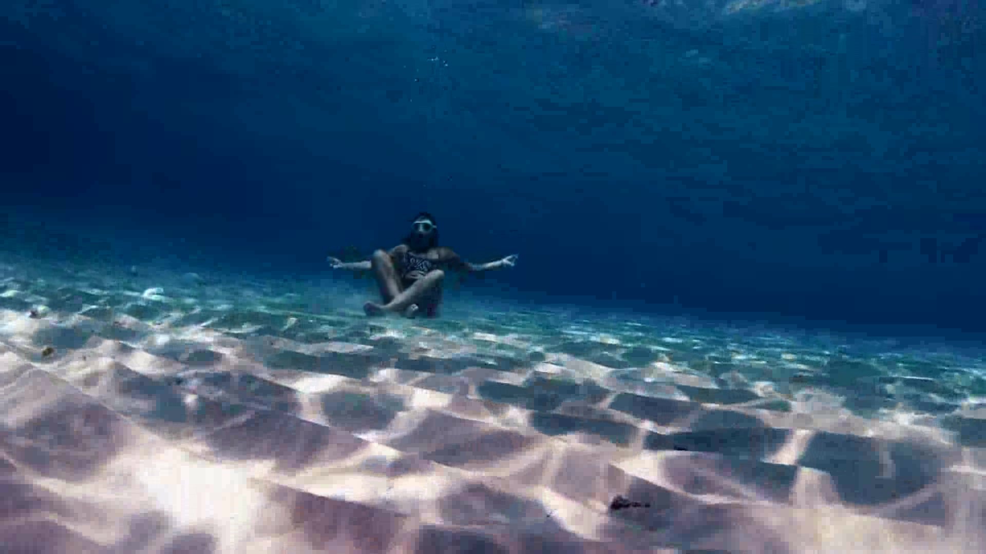 Freedivers breatholding with empty lungs underwater