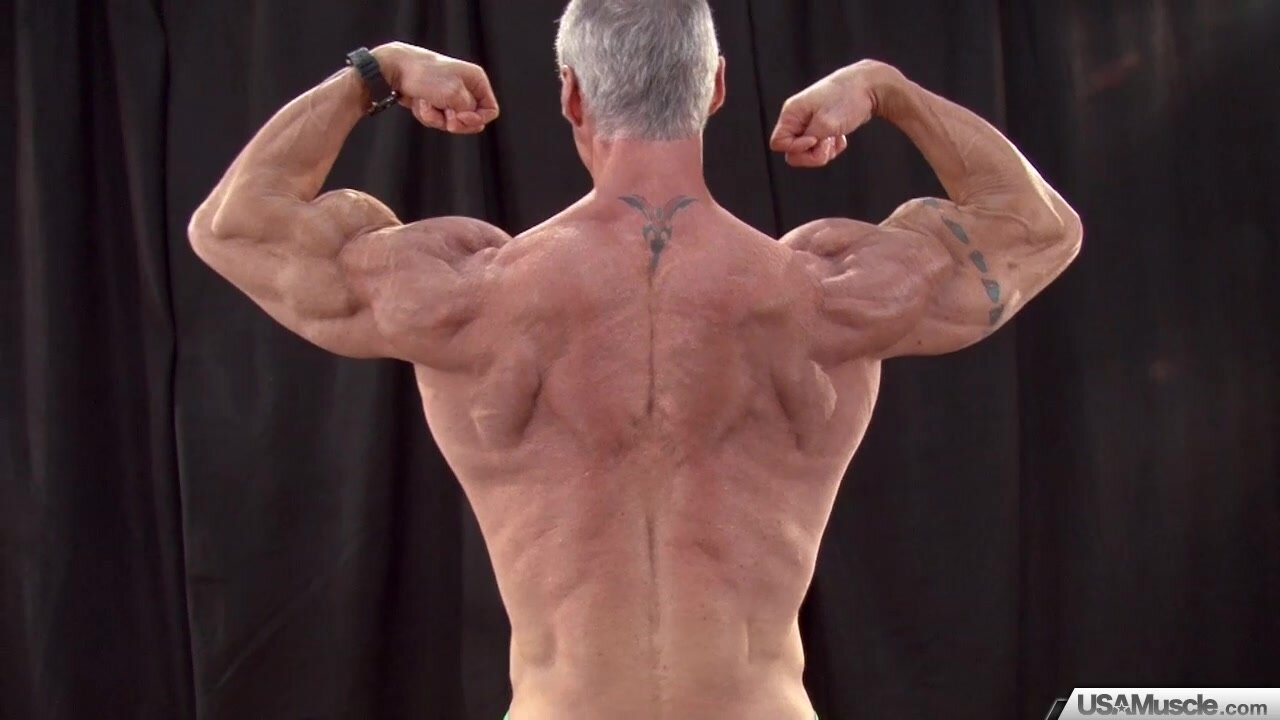 Silver Muscle Daddy Flexes Tight Body for Your Enjoymen