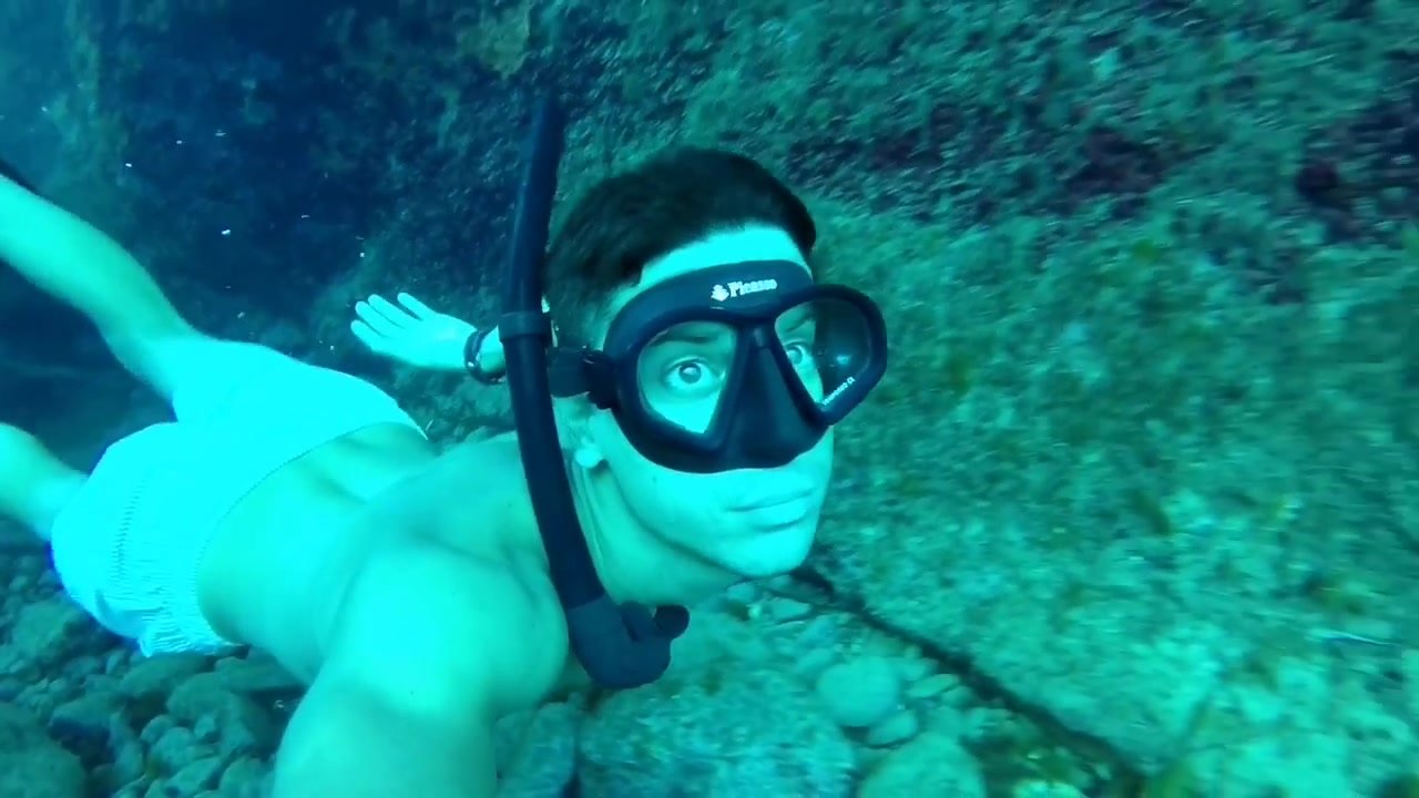 Cutie freediving underwater in cave
