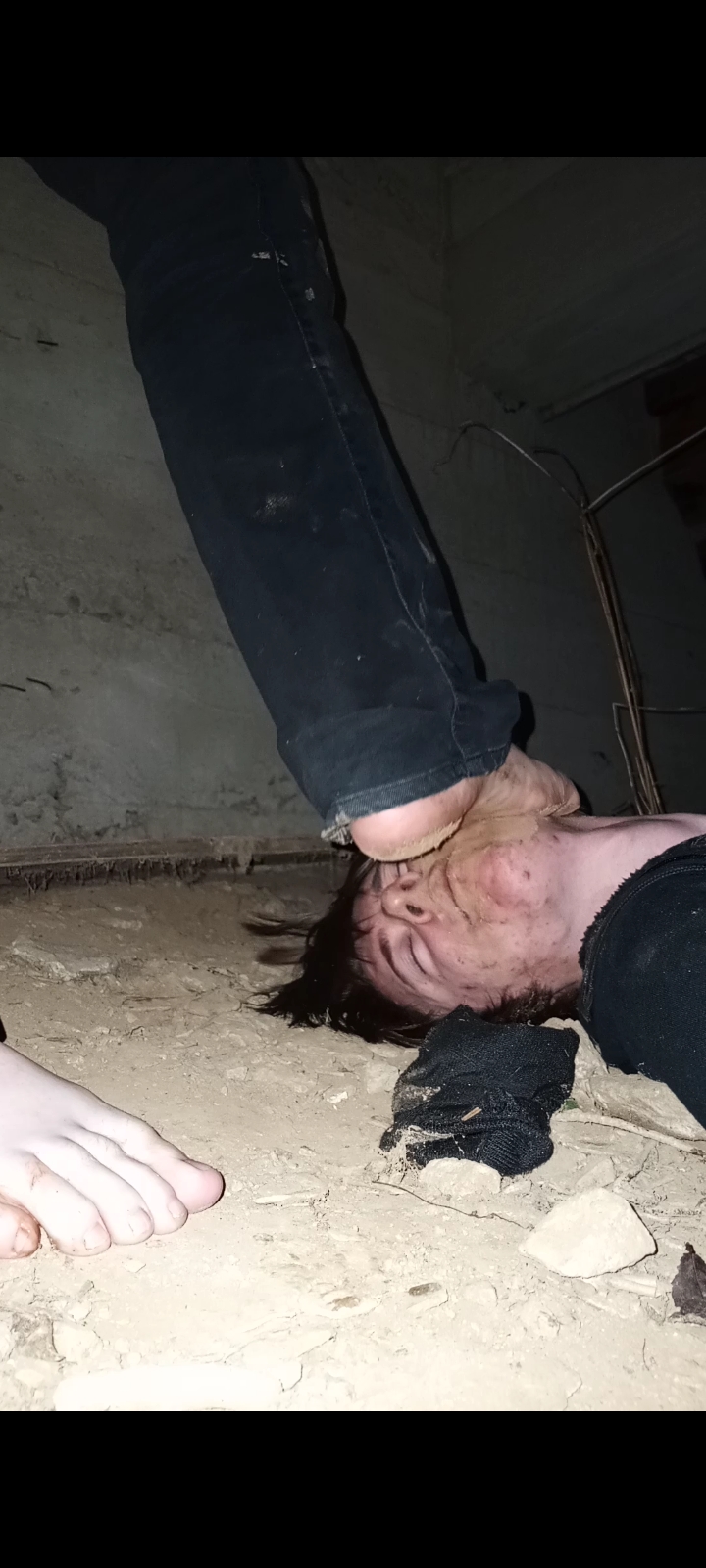 Slave cleans Masters feet in filthy mausoleum crawlspac