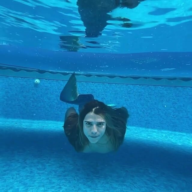 Long haired merman barefaced underwater