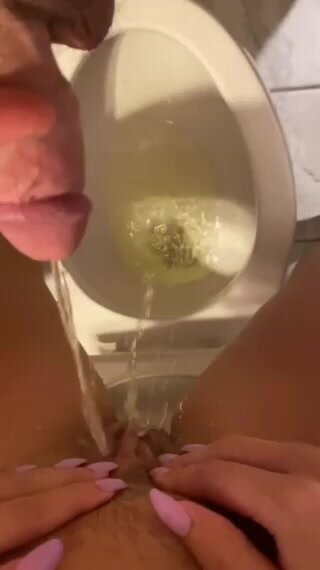 Couple piss in toilet