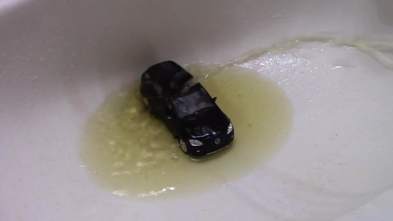 Pissing on a Mercedes Toy Car