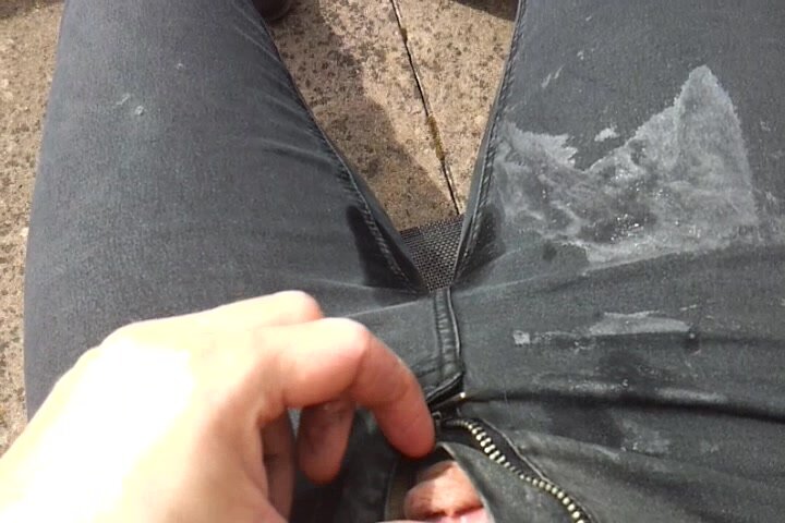 public pissing of trashed jeans and T shirt