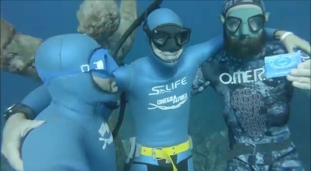 Apnea buddies goofing underwater