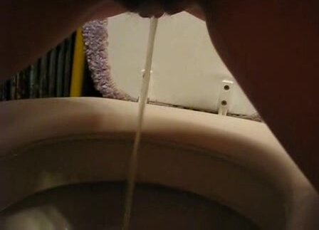 Amateur girl pissing over toilet