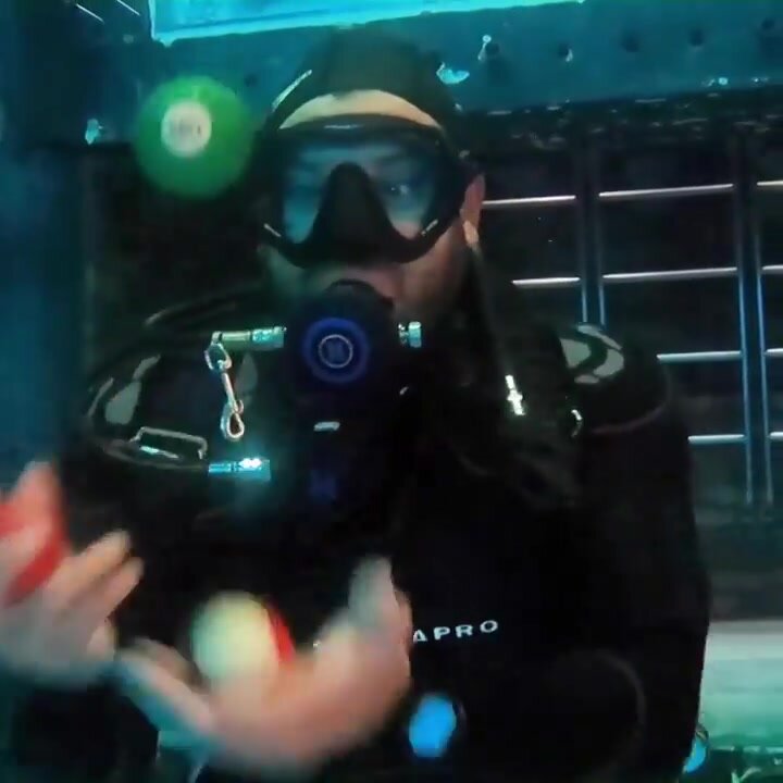 Arab beefy guy underwater in wetsuit