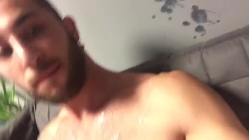 Muscle guys shoots a load on the wall
