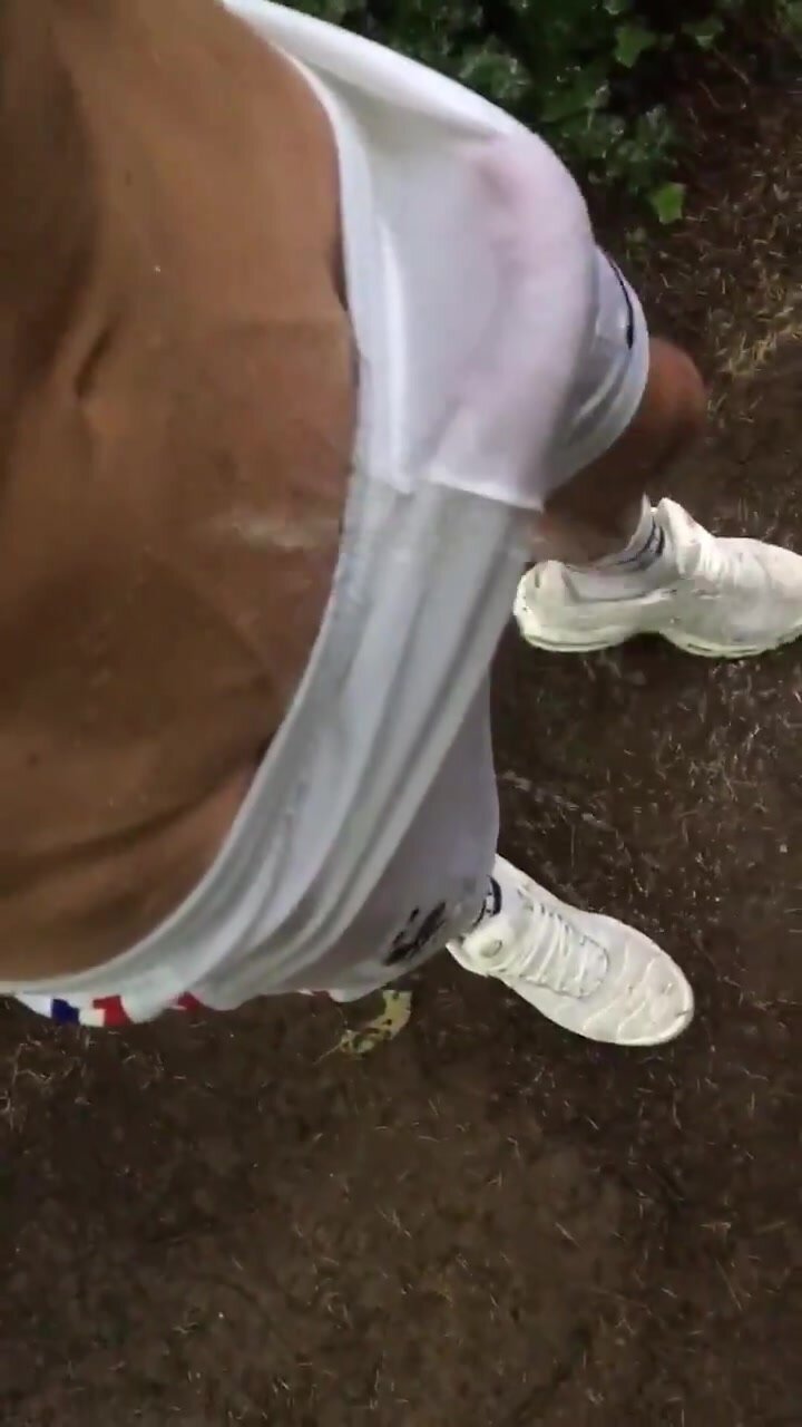 Lad with boner gets pissed on while wearing shorts