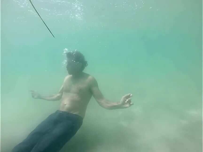 Stripping underwater from jeans to black speedo