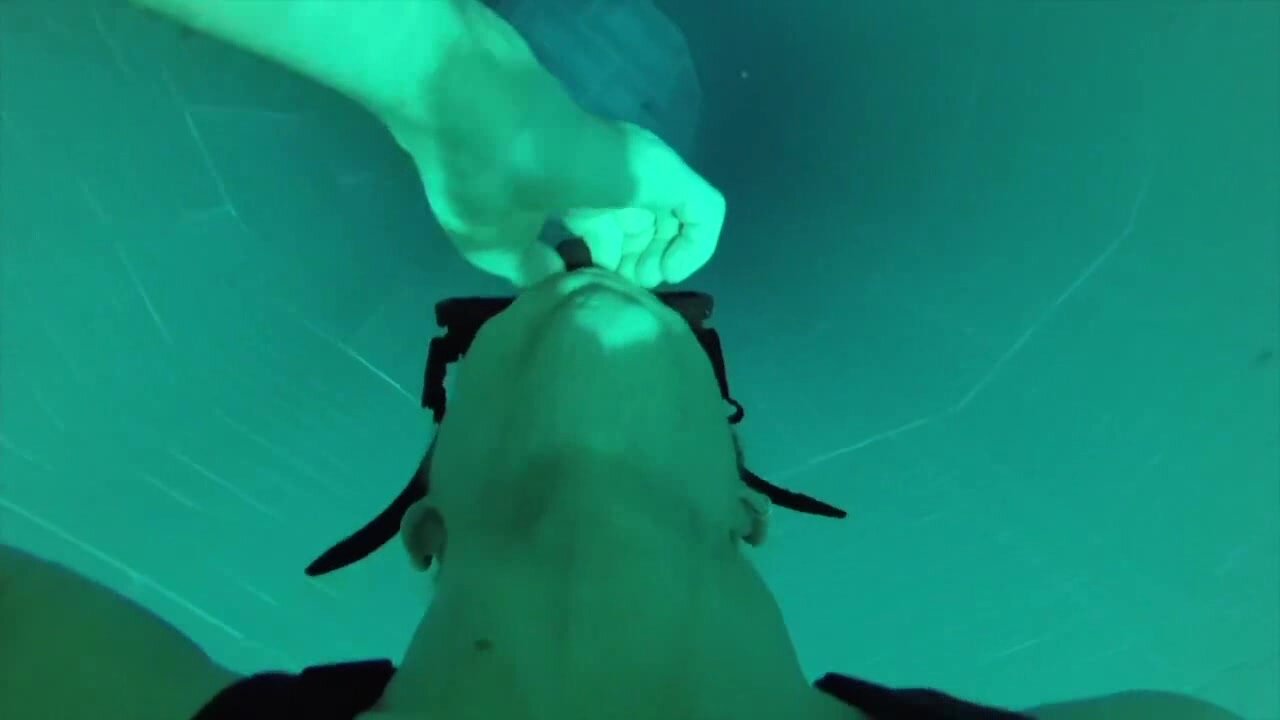Freediving deep underwater in tank