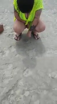 Girl caught pissing at the beach