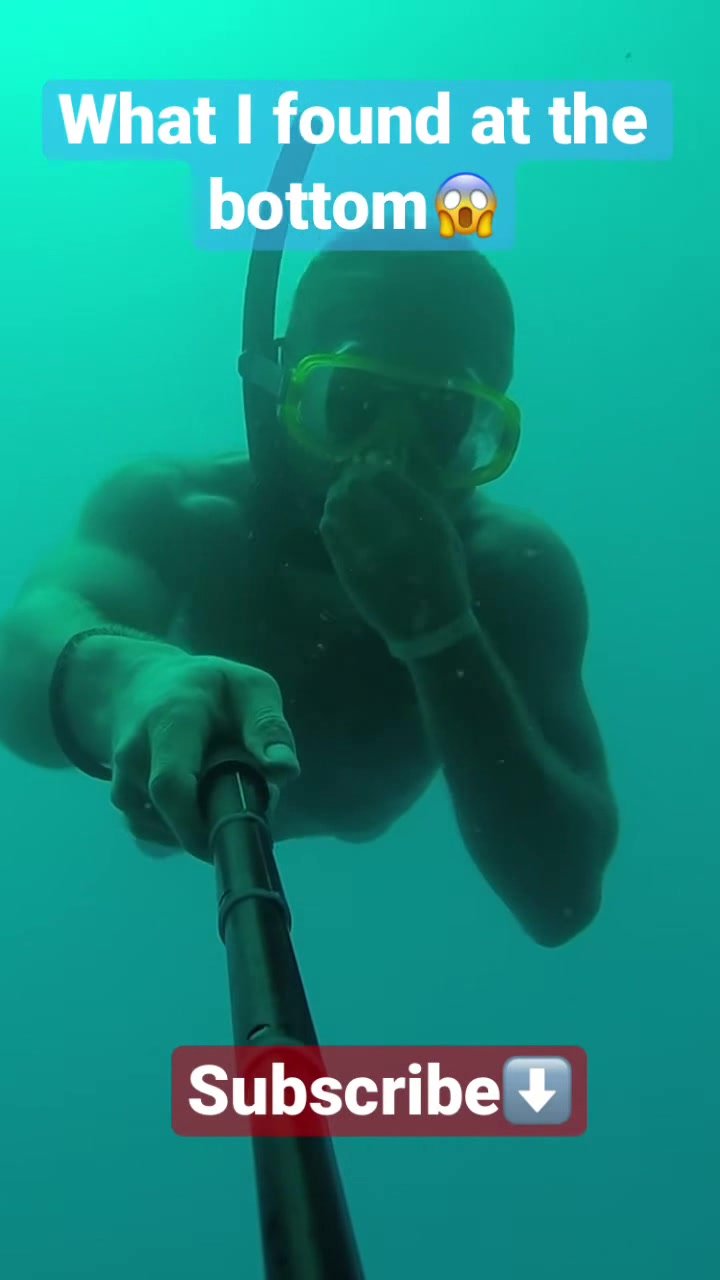 Fit freediver underwater in bulging speedos