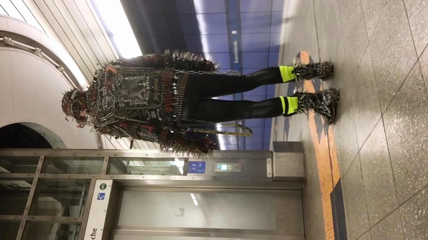 Punk with large spikes hanging around at Munich Metro