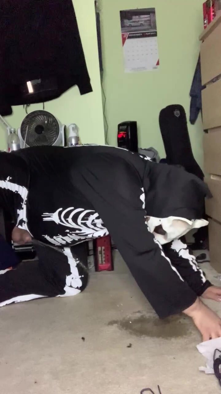 Pissing like a dog in skeleton suit