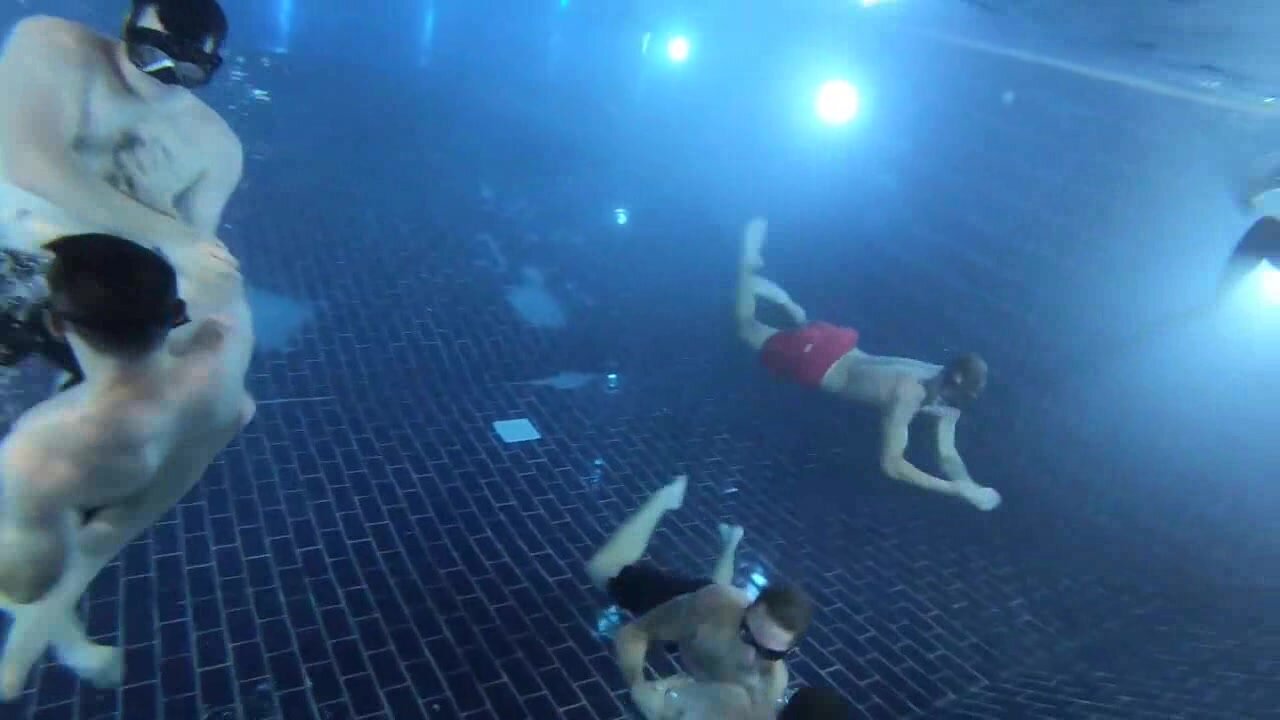 Fit guys playing underwater football
