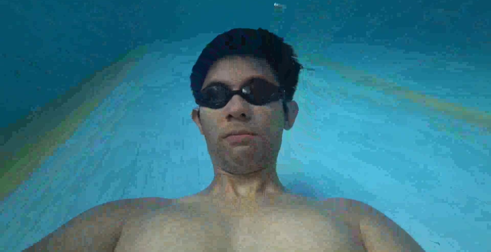 Asian guy underwater with goggles
