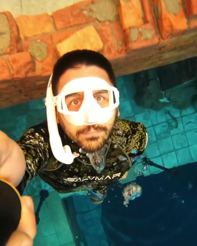 Underwater breatholding selfie in wetsuit