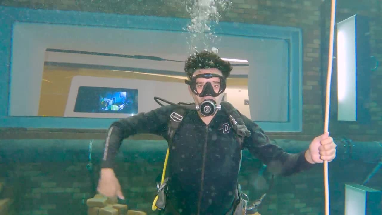 Arab scubadiver underwater in water tank