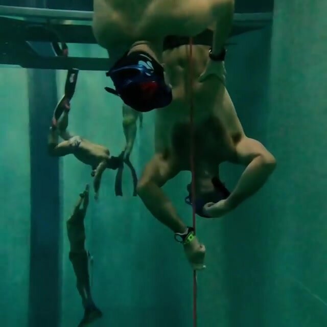 Underwater italian freedivers in bulging speedos