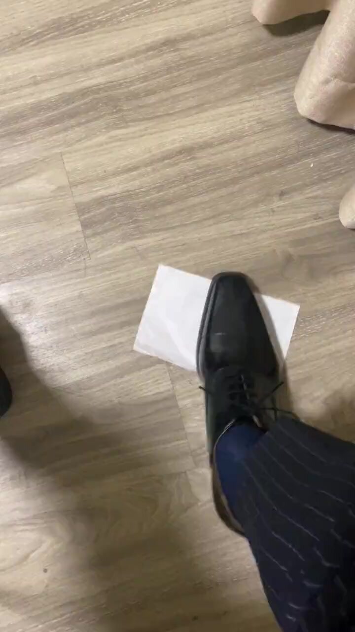Male dress shoes trample paper