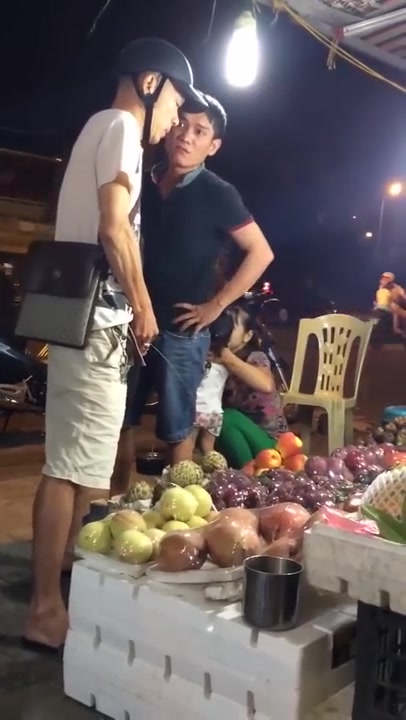 Man pissing on a fruit stand