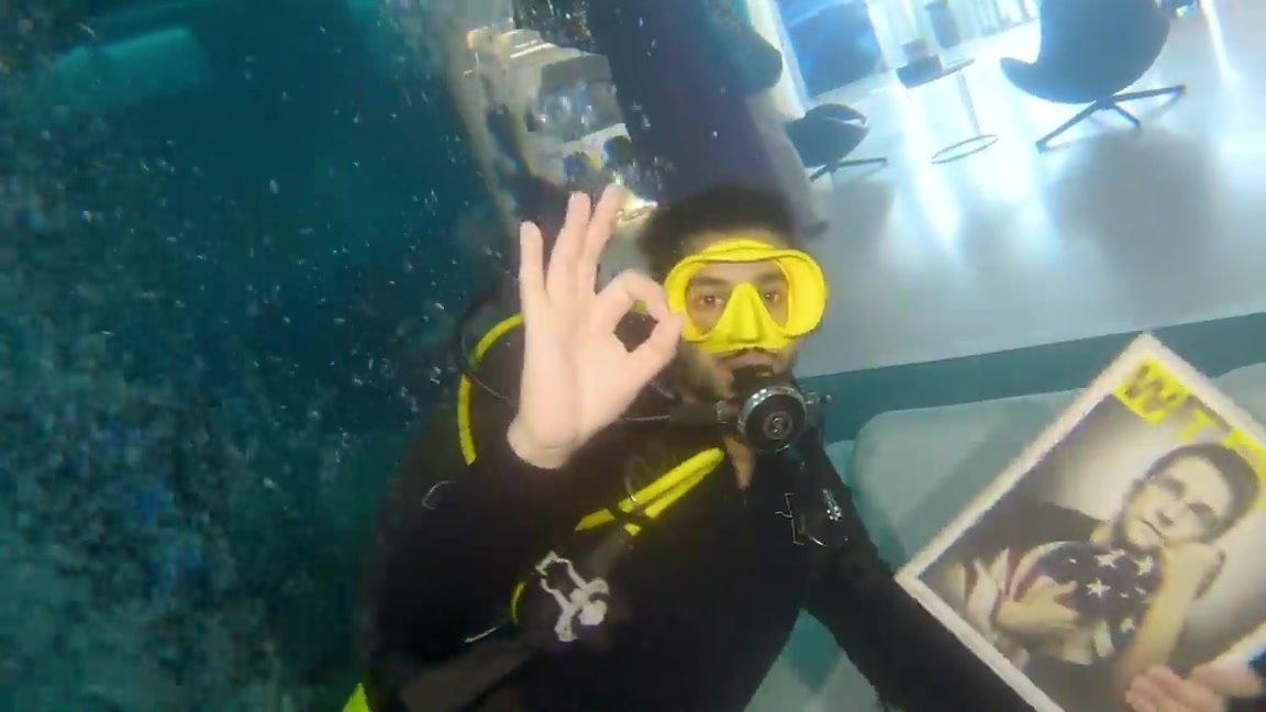 Arab scubadiver underwater in deep water tank