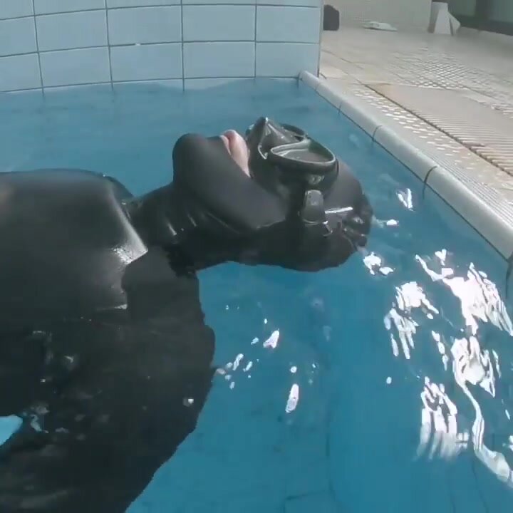 Various freedivers underwater in pool