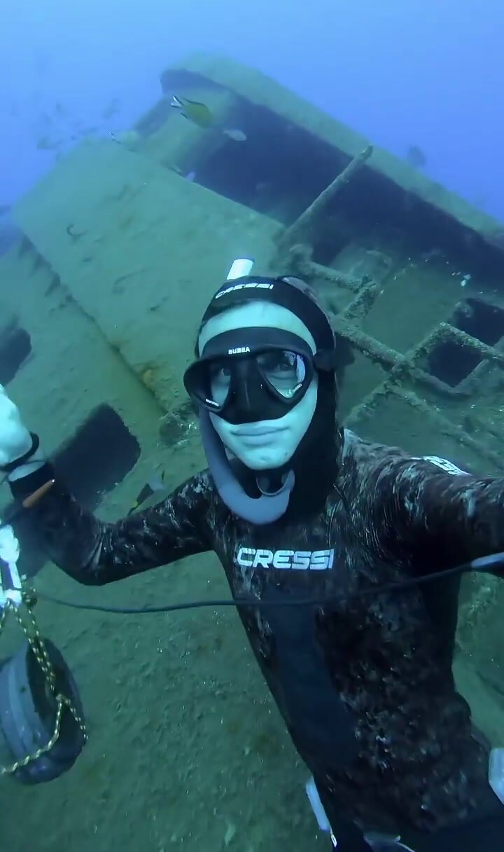 Fit freediver underwater in tight wetsuit