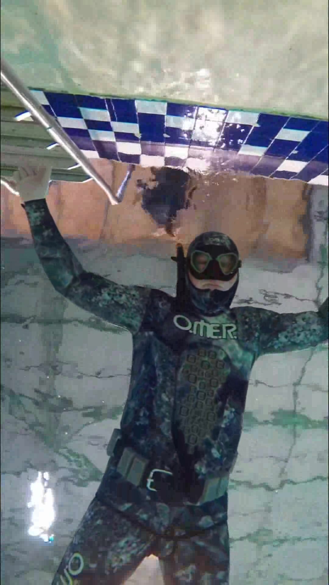 Underwater Beefy Freediver In Tight Wetsuit