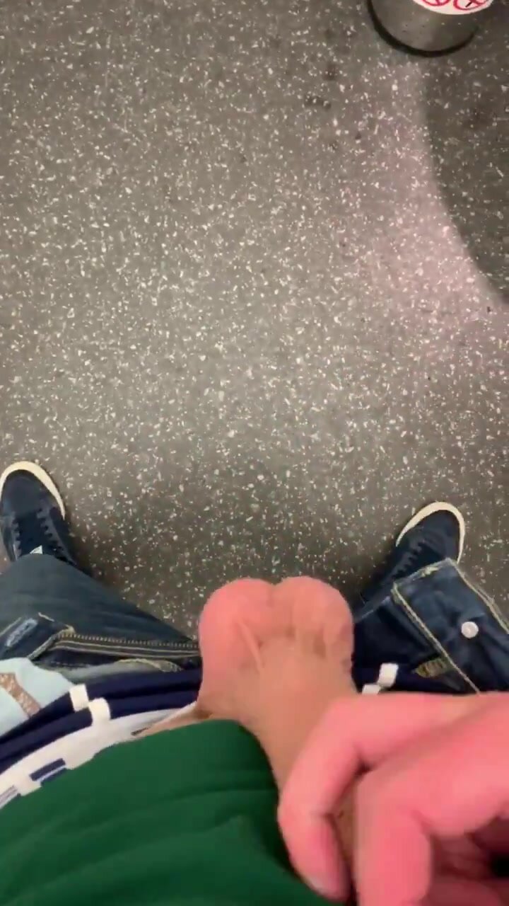 Playing with his hefty cock and balls in public toilet