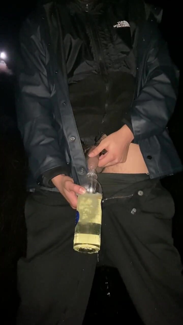 Filling up a bottle with warm piss outdoor