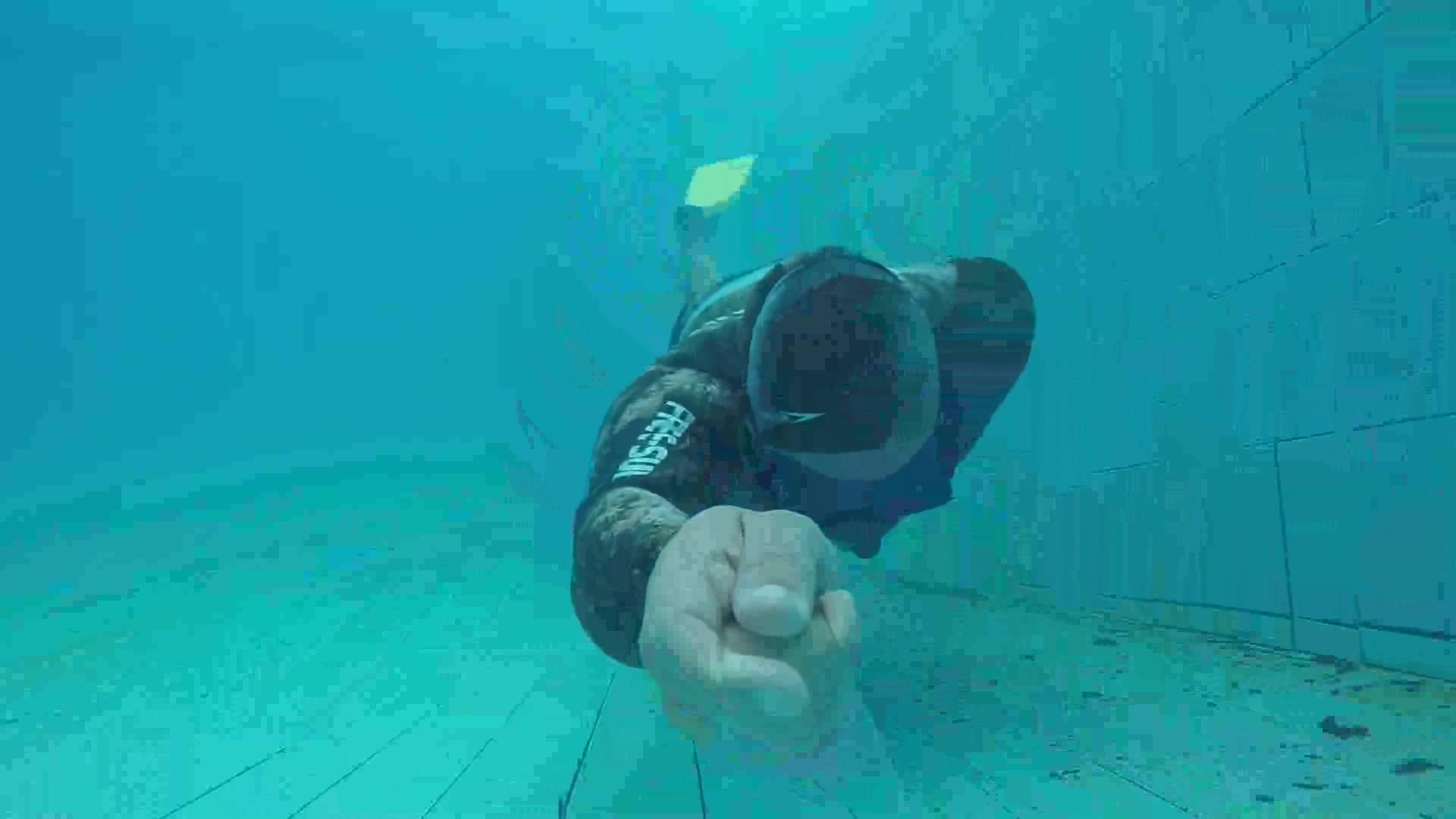 Kareem breatholding underwater in wetsuit