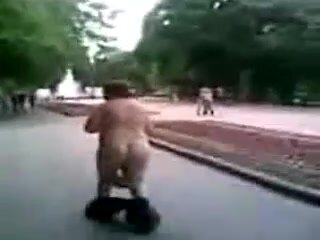 Fat guy walks on the street with pants down