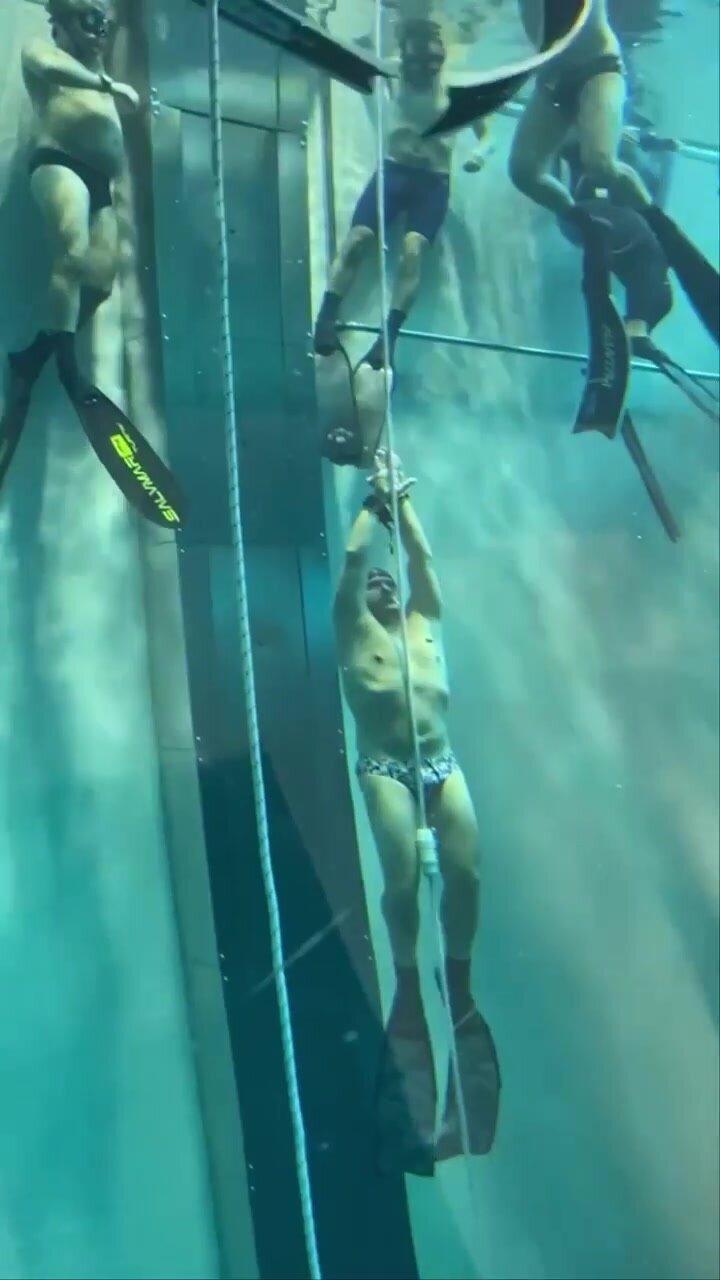 Underwater freedivers in tight speedos
