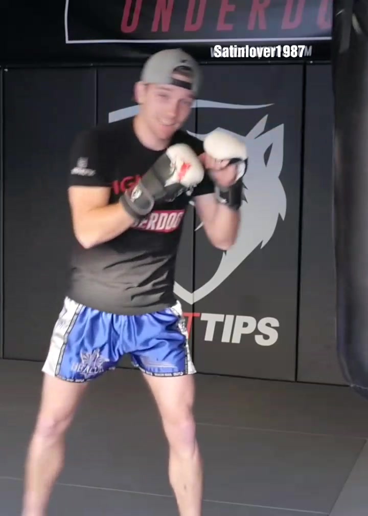 Handsome guy in shiny blue kickboxing shorts