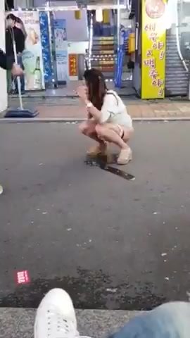 Girl peeing on the street 1