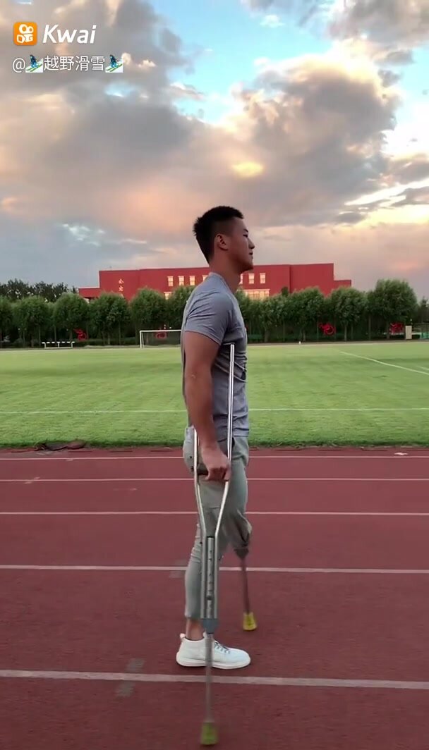 Amputee Chinese athlete on crutches