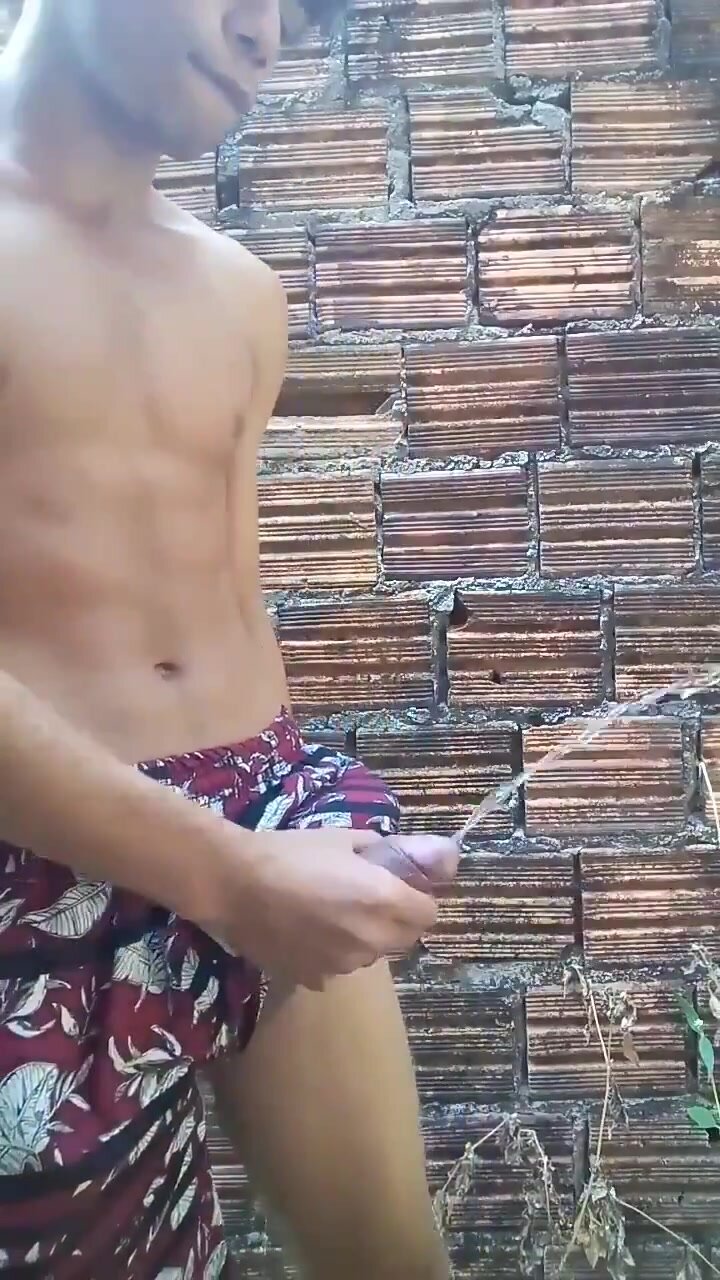 boy with hard dick pissing outside