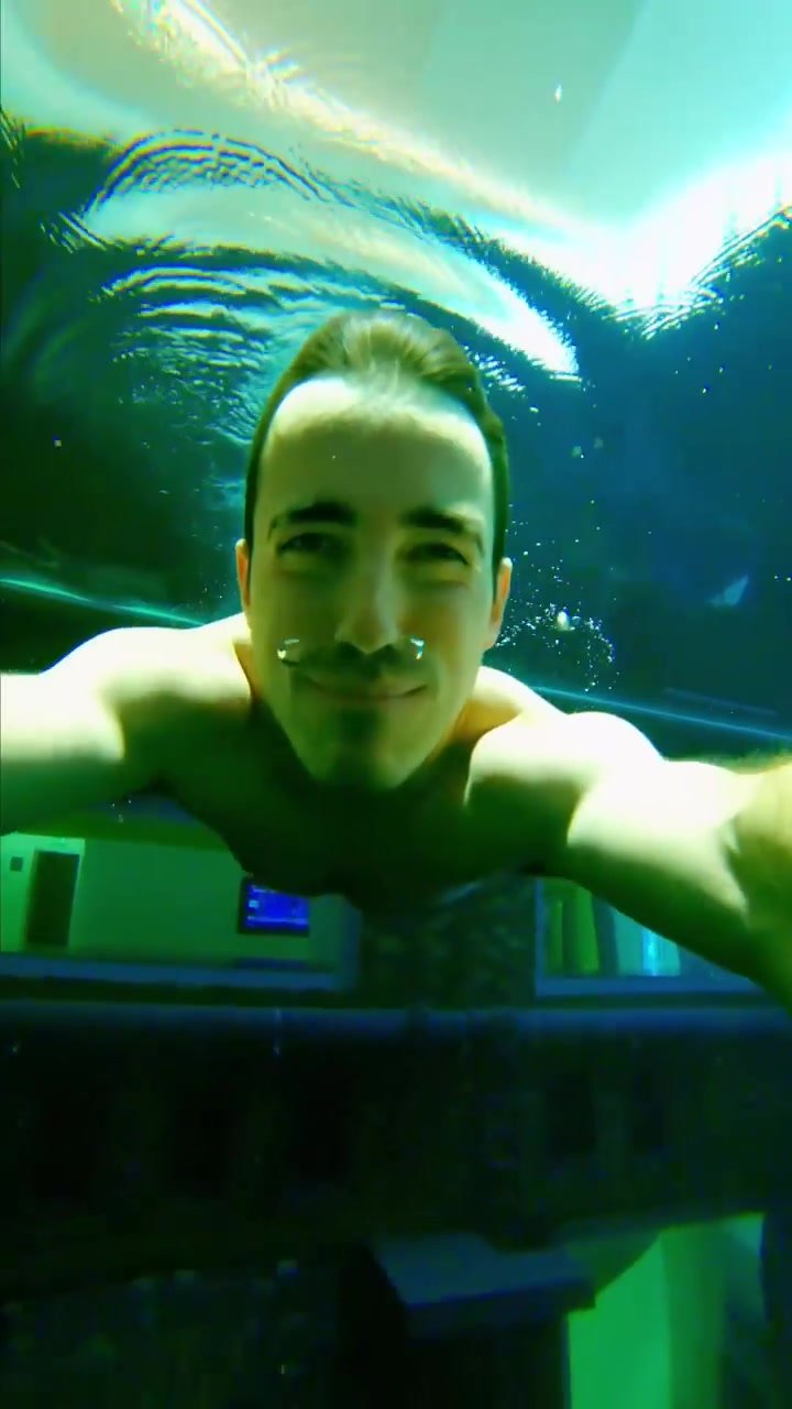 Barefaced and scuba underwater in water tank