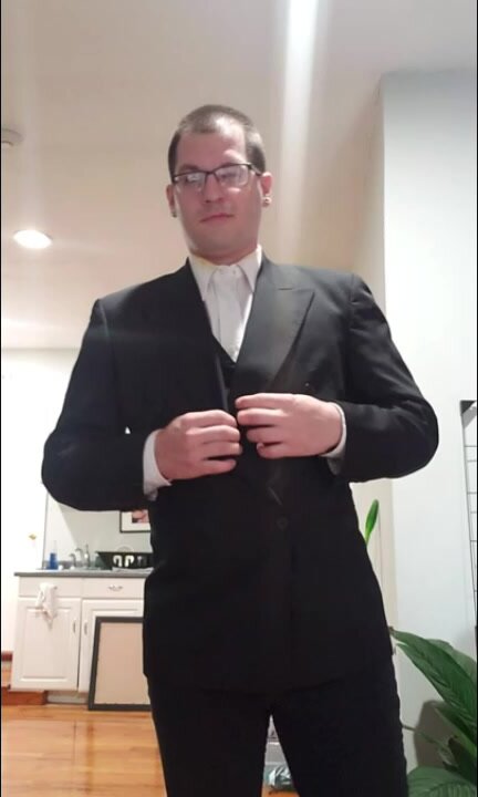 Dan strips out of a tux