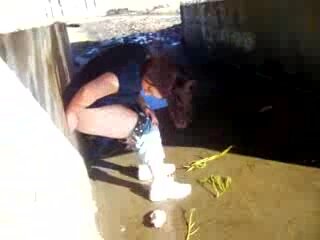 trashlee peeing under a bridge