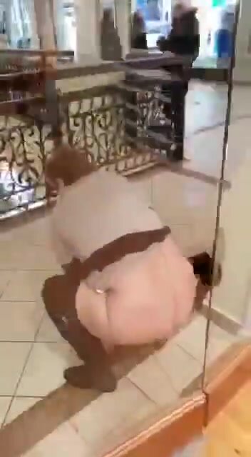 Woman peeing in mall