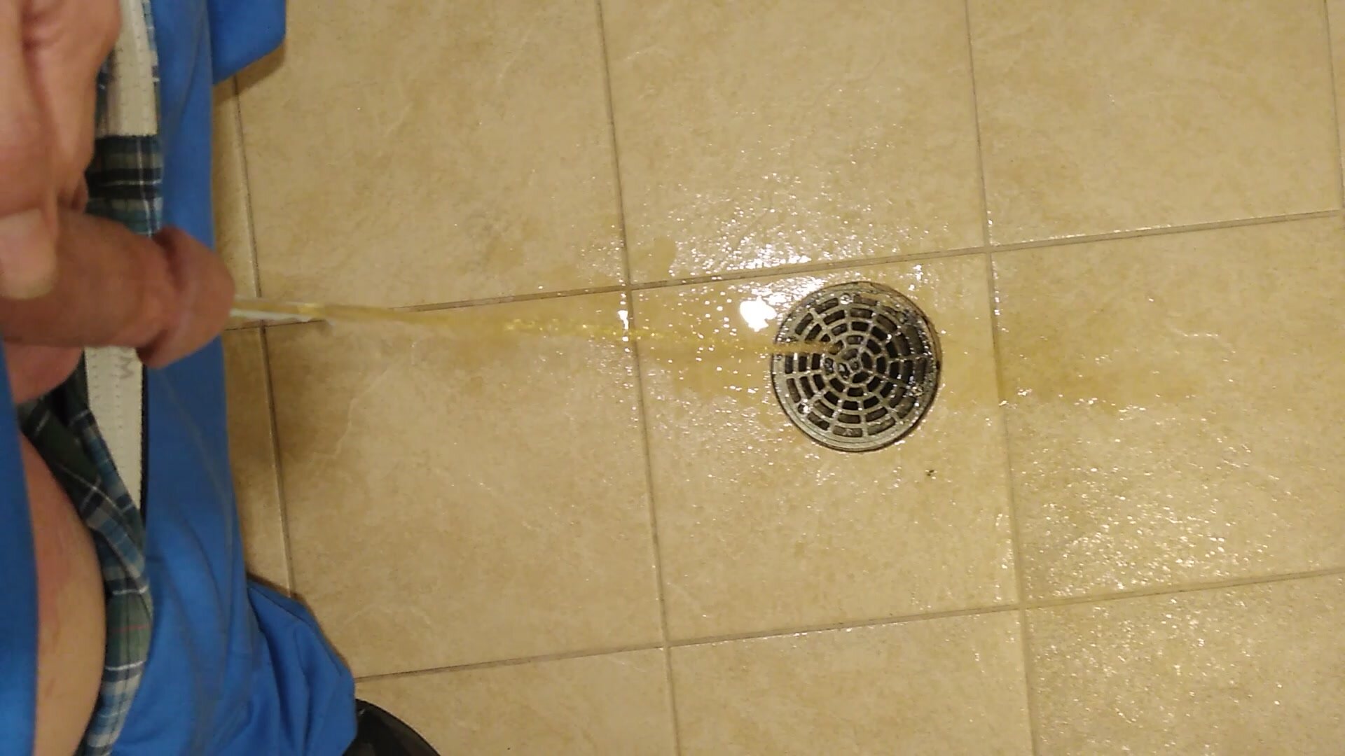 Pissing down the floor drain at work