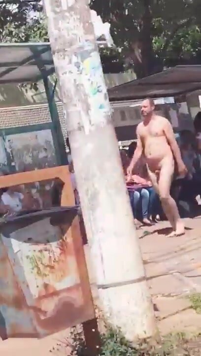 Naked man walking by the street
