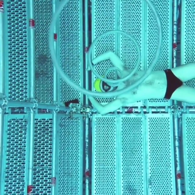 Italian freediver blowing air rings underwater