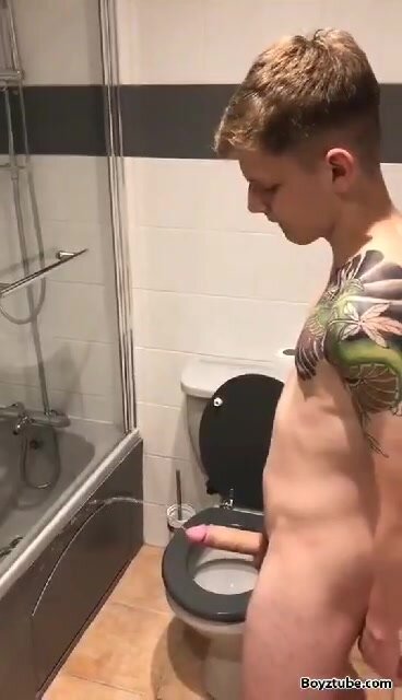 Tattoo boy pisses in bathroom