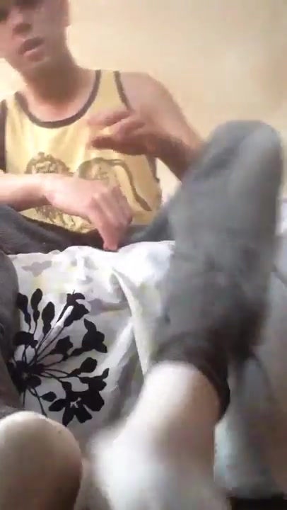 Teen master shows off his sweaty bare feet after doing a sock strip