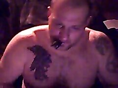 Tattooed musclebull smokes cigar and plays offcam